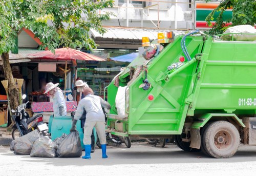 Loading construction debris into a builders skip